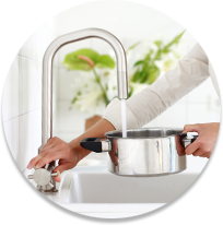 Water pouring from sink into cooking pot