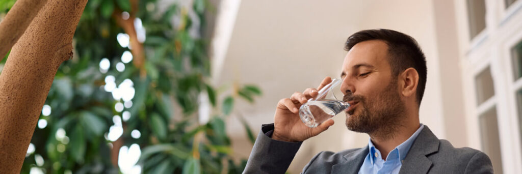 Man drinking water from glass